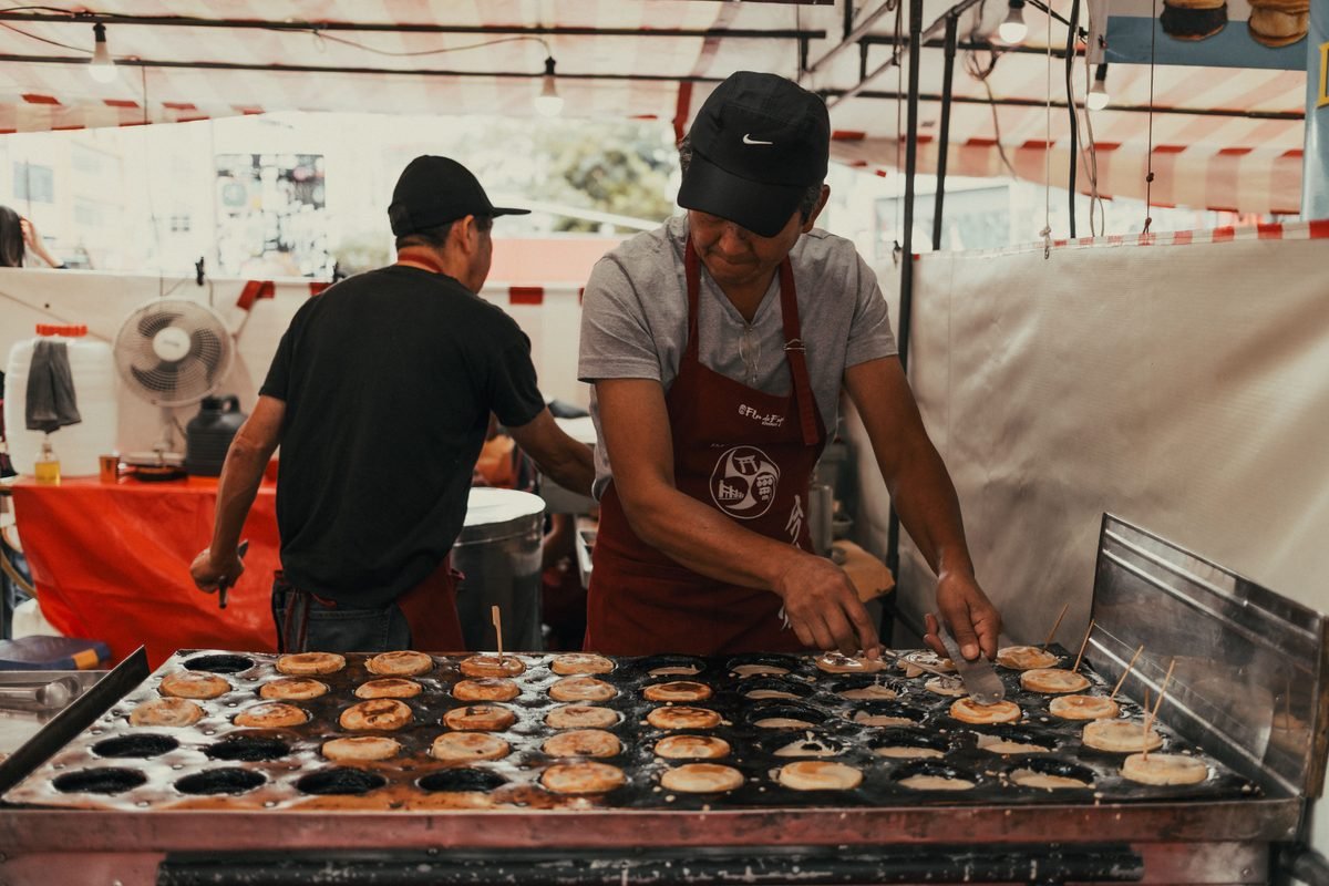 Street food vendor preparing snacks at a market stall