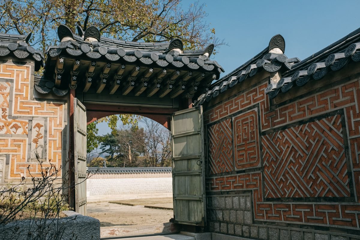 Traditional Korean gate and brick wall in Seoul.