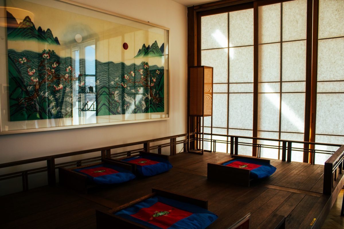 Serene tea room interior with wooden flooring and cushions