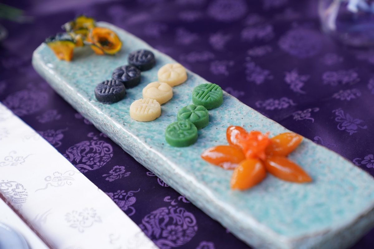 Traditional Korean sweets arranged artistically on a ceramic plate
