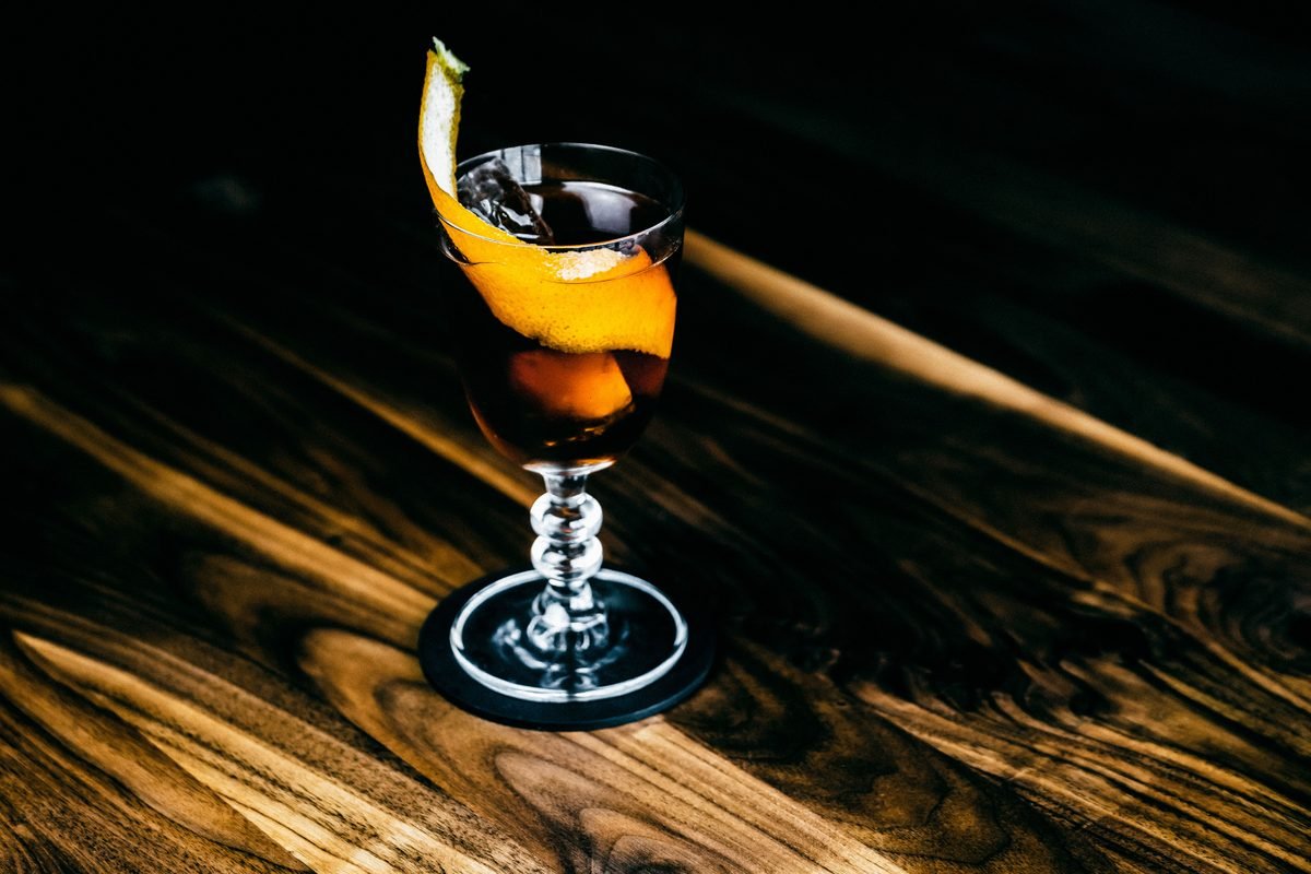 A beautifully crafted cocktail with an orange twist