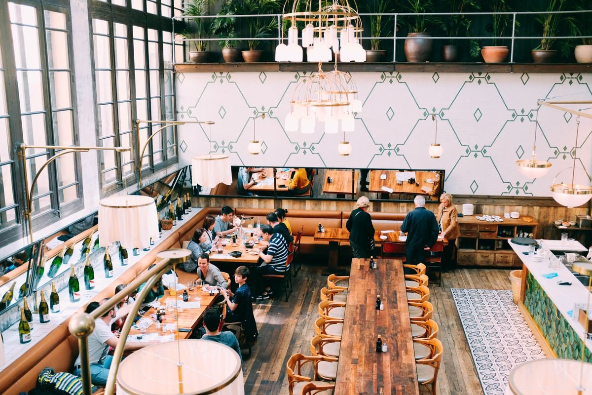 Spacious restaurant with stylish interior design and wooden tables