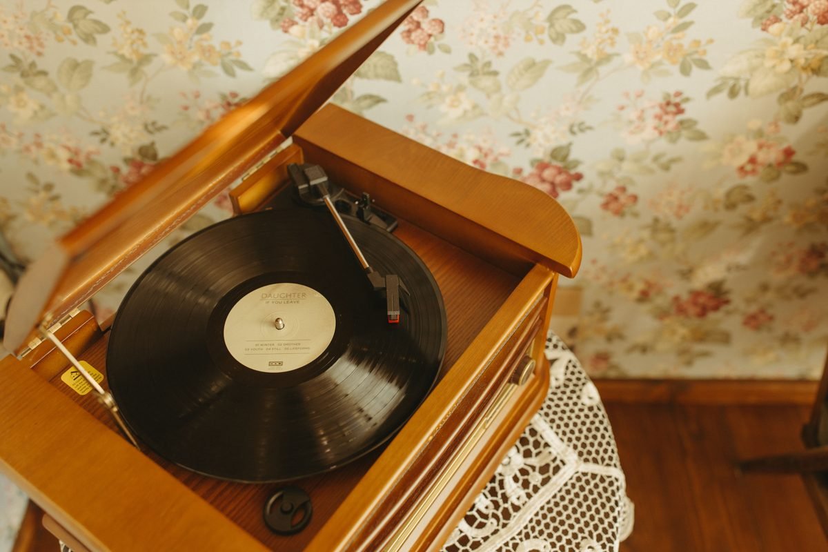 A vintage turntable playing a vinyl record in a retro interior
