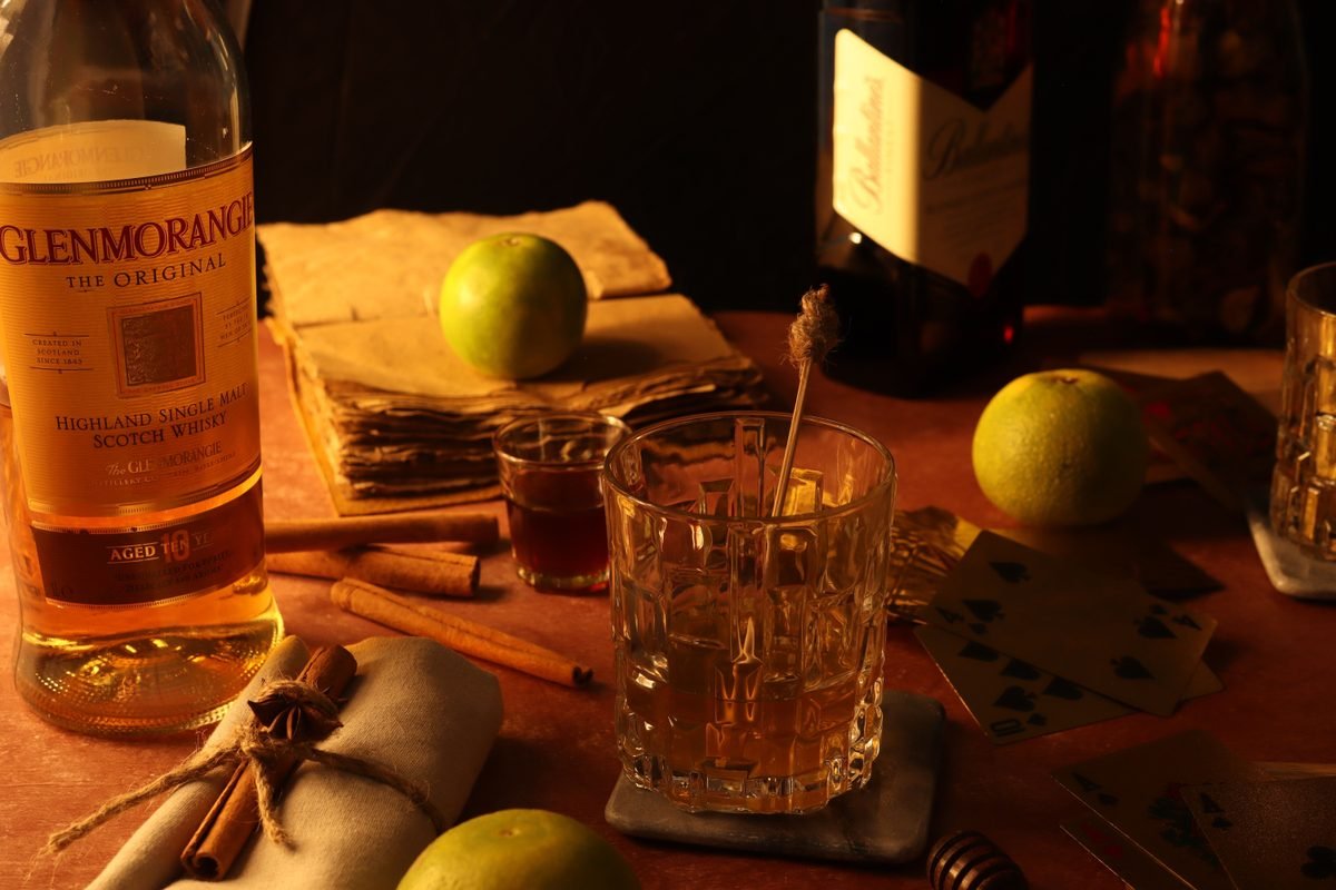 Warm still life featuring whisky and a bottle of Scotch