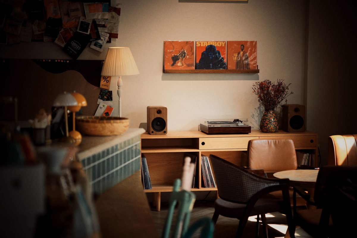 Warm vintage record player setup with speakers and vinyls