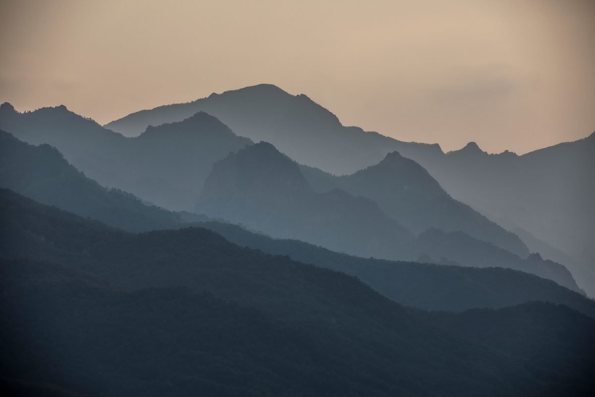 Mist rising over the layered ridges of Seoraksan mountains at dawn.
