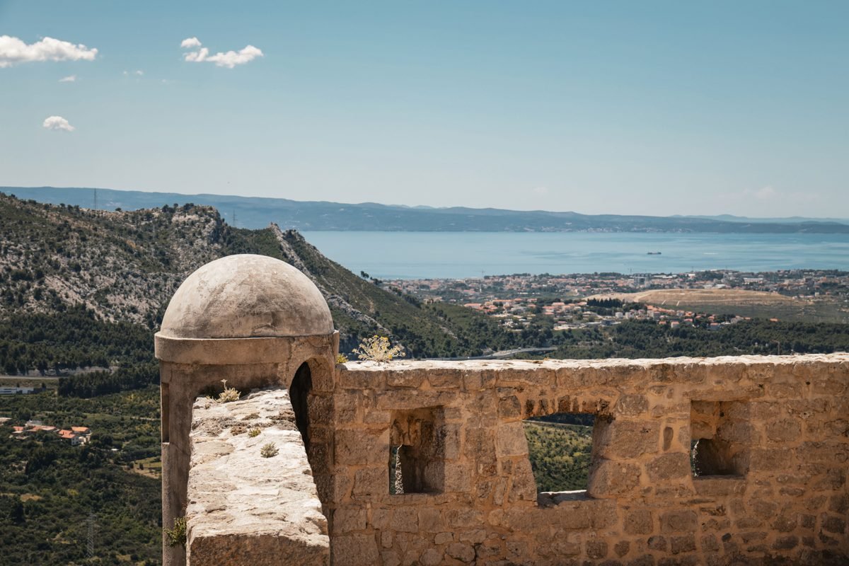 Stone ramparts and defensive stone dome overlooking a valley and sea