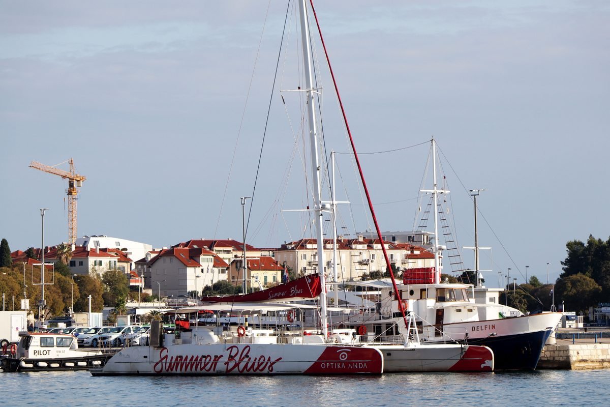 Catamarans and yachts docked in Split harbor on a sunny day