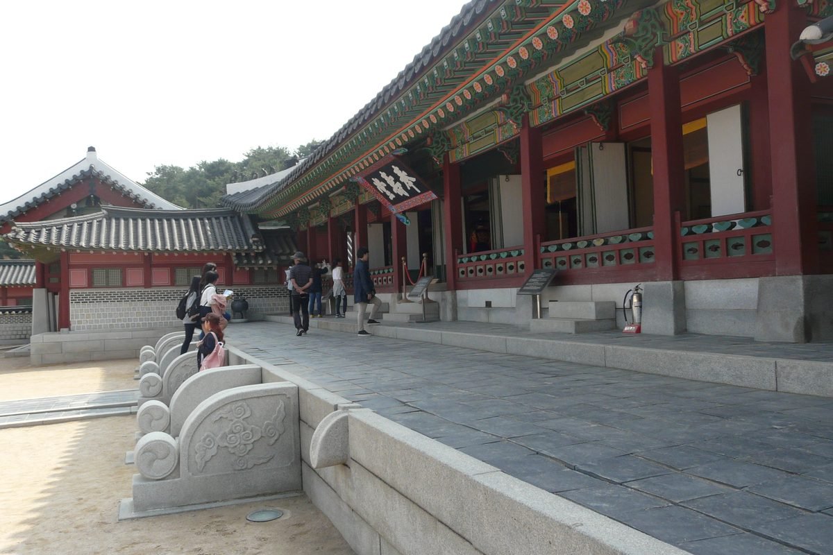 Traditional Korean architecture with tiled roof and ornate pillars at Hwaseong Fortress