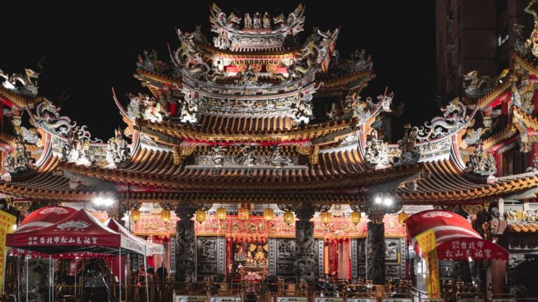 Ornate glowing temple facade at Raohe Street Night Market in Taipei