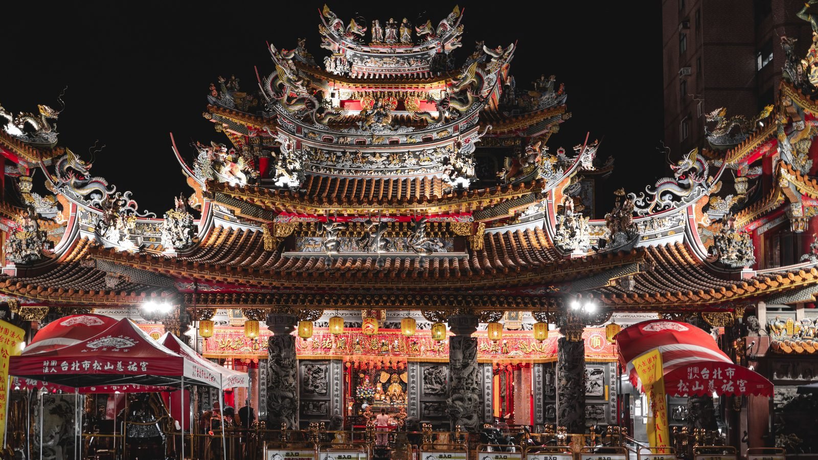 Ornate glowing temple facade at Raohe Street Night Market in Taipei