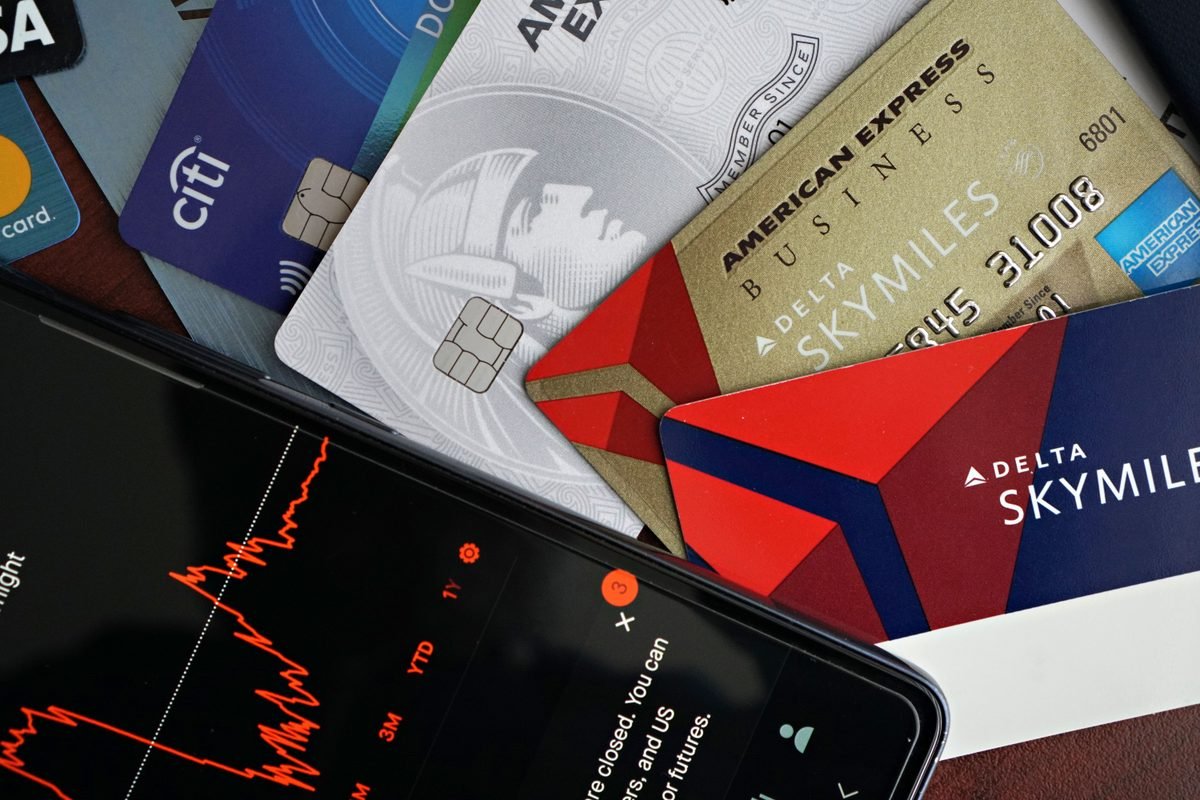 Credit cards and smartphone displaying a financial graph.
