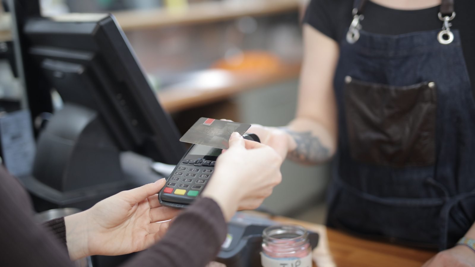 Customer and cashier during a credit card transaction.