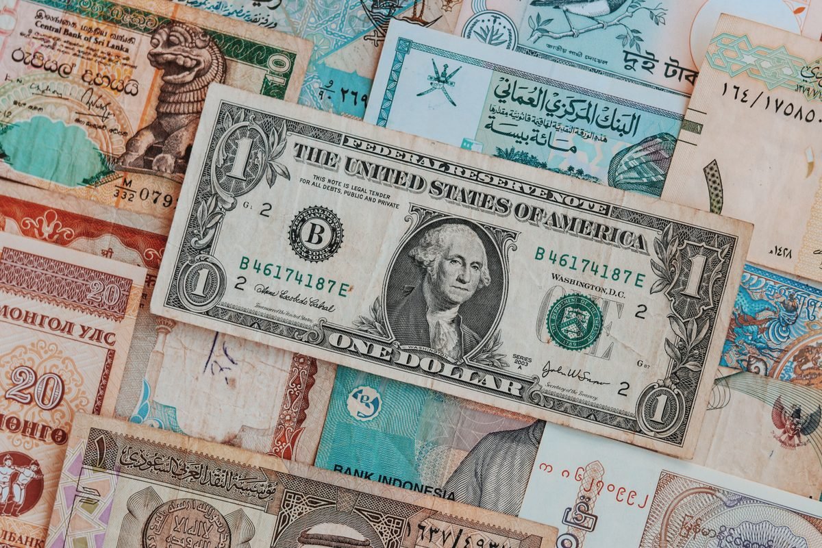 Top view of assorted paper money with US dollar bill.