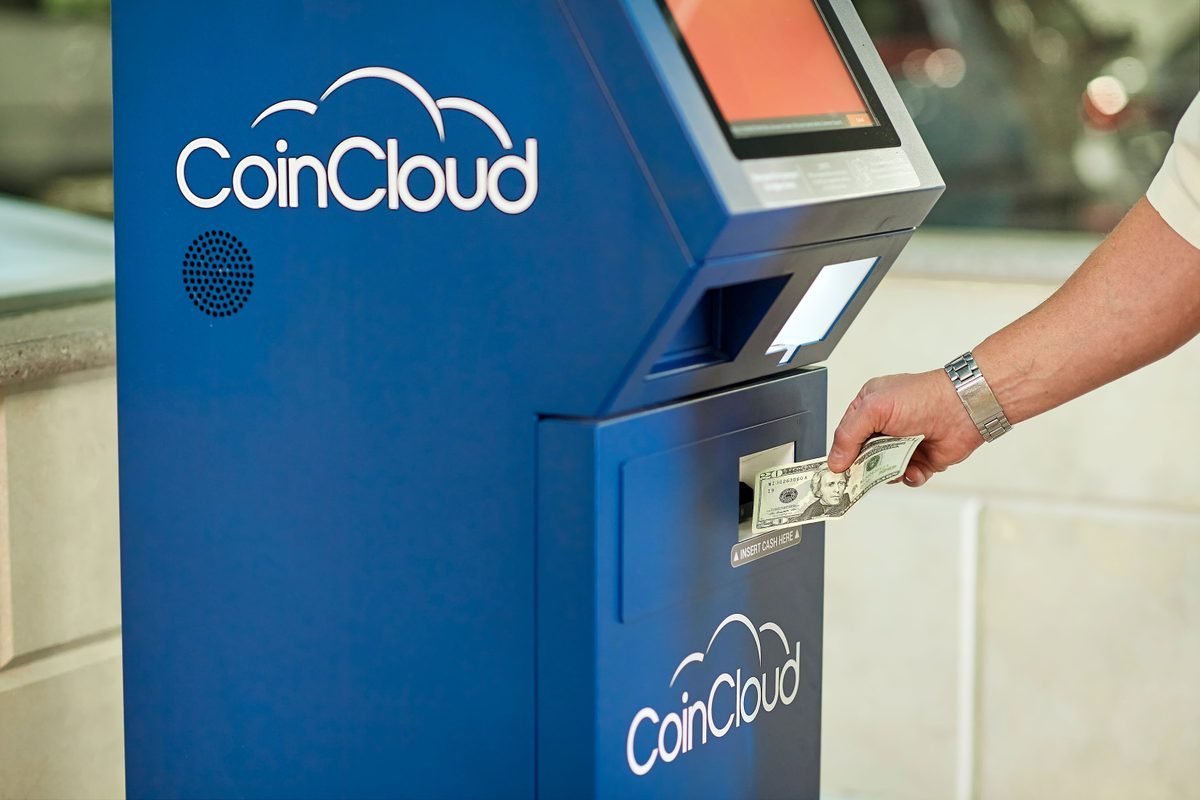 Person using a CoinCloud ATM for transactions.